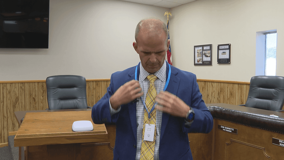 Jackson County Schools Superintendent Will Hosaflook demonstrates how the button works. (WCHS)